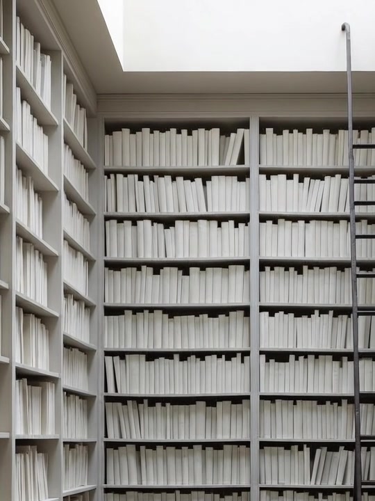 A row of blank cloth book spines with no letters.